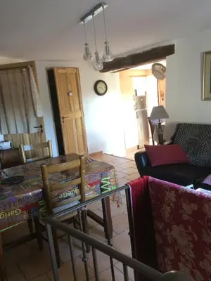 a living room with a table and a couch at L'Oustaou de Rose in Bonnieux