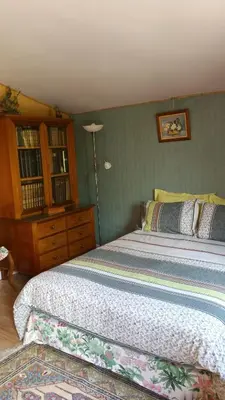 a bedroom with a large bed and a dresser at Coin Secret in Murs