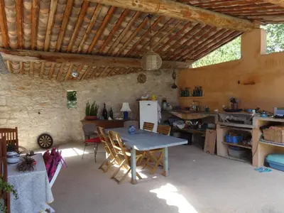 a room with a table and a kitchen in a building at Coin Secret in Murs