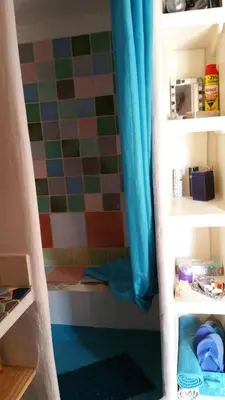 a bathroom with a shower curtain in a room at Coin Secret in Murs