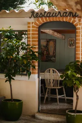 a chair sitting in the doorway of a house at Les intérieurs d'Angèle in Pernes-les-Fontaines