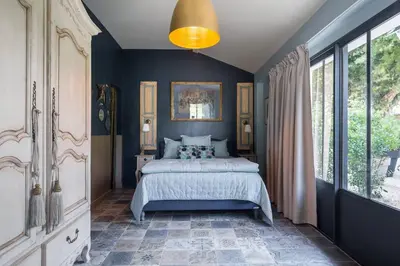 a bedroom with a bed and a large window at Les intérieurs d'Angèle in Pernes-les-Fontaines