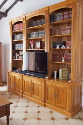 a wooden entertainment center with a television in a room at Les murmures du Temps Villa 3 Chambres avec Piscine in Carpentras