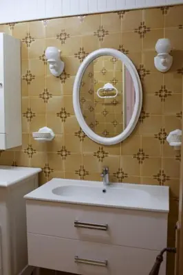 a bathroom with a sink and a mirror at Les murmures du Temps Villa 3 Chambres avec Piscine in Carpentras