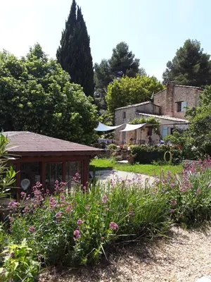 a garden with a gazebo and flowers at Le Paradis in Vaugines