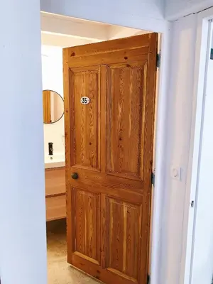 a wooden door in a hallway in a room at Nuits étoilées Lourmarin in Lourmarin