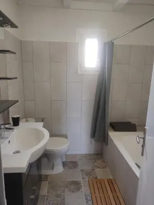 a bathroom with a sink and a toilet and a bath tub at Maisonnette in Carpentras