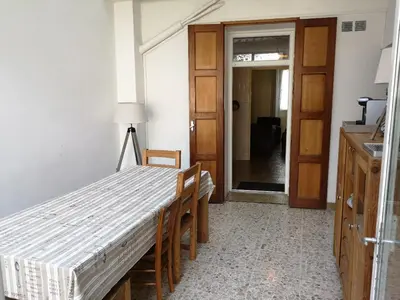 a room with a bed and a table and a door at La maison Bleue in Céreste