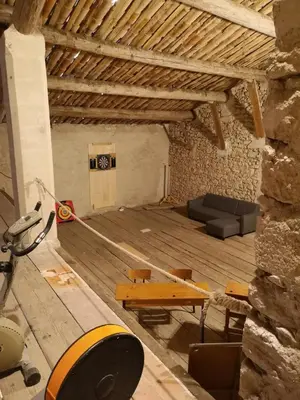 a living room with a couch and a table at La maison Bleue in Céreste