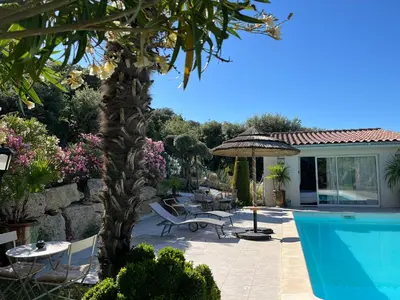 a patio with a swimming pool and a house at La Thomalie in Crillon-le-Brave