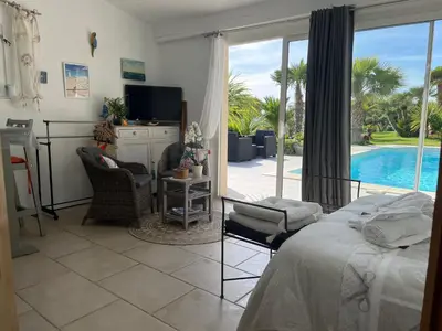 a bedroom with a bed and a view of a pool at La Thomalie in Crillon-le-Brave