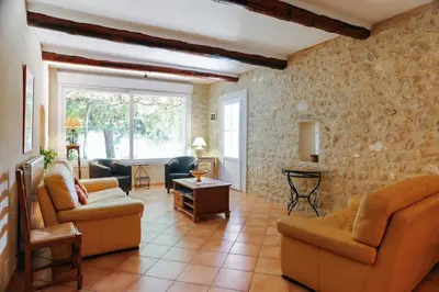 a living room with two couches and a table at Villa confortable à Caromb avec piscine privée in Caromb