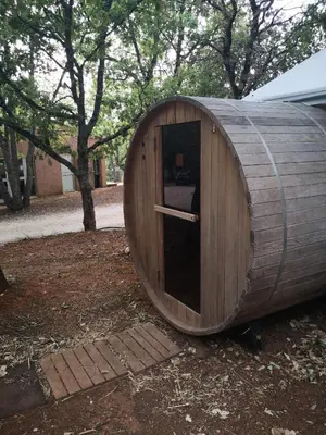 a large wooden hobbit house sitting in a yard at La Colline des Ocres Village de vacances 3 étoiles in Apt