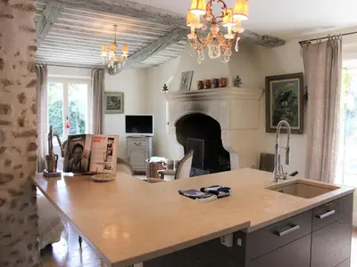 a kitchen with a counter top and a fireplace at Mas in Eygalières with Heated Pool in Eygalières