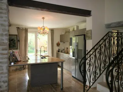 a kitchen with a counter and a staircase in a room at Mas in Eygalières with Heated Pool in Eygalières
