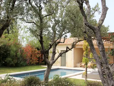 a pool in the backyard of a house with trees at Mas in Eygalières with Heated Pool in Eygalières