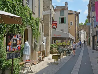 a little girl walking down a street with buildings at Mas in Eygalières with Heated Pool in Eygalières