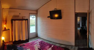 a corner of a room with a television on the wall at le Mas de la Jardine in Velleron