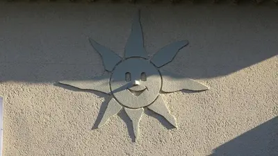 a smiley face on the side of a wall at le Mas de la Jardine in Velleron