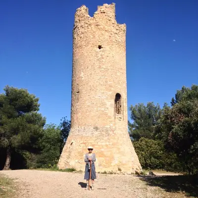 a man standing in front of a tall tower at Villa Les Cedres in Aix-en-Provence