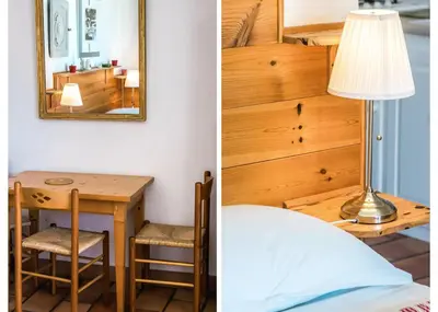 a room with a bed and a table and a lamp at Mas Clair de Lune in Saint-Rémy-de-Provence