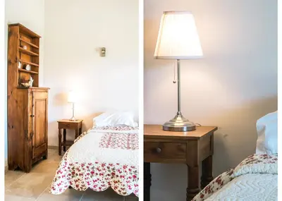 a bedroom with a bed and a lamp on a table at Mas Clair de Lune in Saint-Rémy-de-Provence