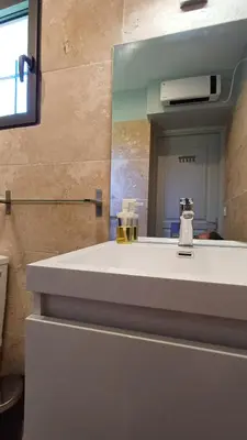 a bathroom with a white sink and a mirror at La Goutadou in Cabannes