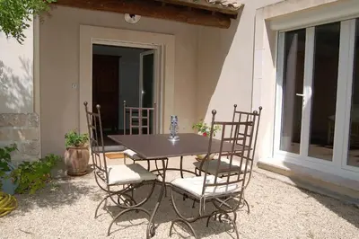 a table and chairs sitting on a patio at La Goutadou in Cabannes