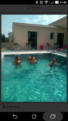 two people are swimming in a swimming pool at Les Figues in Caromb