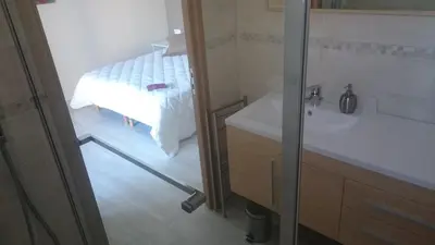 a bathroom with a bed and a sink and a shower at Les Figues in Caromb