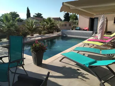 a group of lawn chairs sitting next to a swimming pool at Les Figues in Caromb