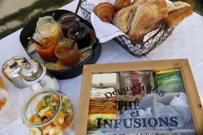 a table with bread and a picture and a basket of food at Chambres entre Ventoux et luberon in Sault-de-Vaucluse