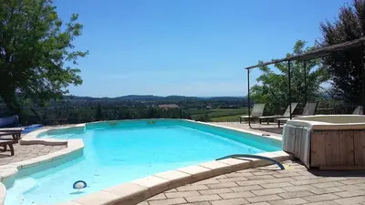 a large swimming pool with a view of the mountains at Amandier in Mazan