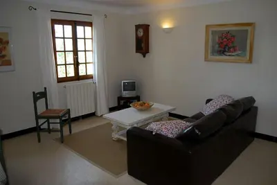 a living room with a couch and a table at Amandier in Mazan