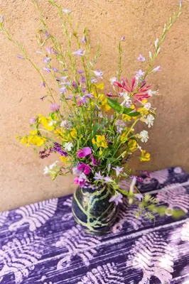 a vase filled with flowers sitting on a table at Poterie de Pierroux in Roussillon