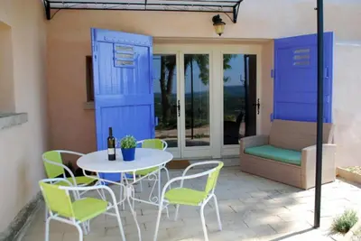 a patio with a table and chairs and a couch at Olivier in Mazan