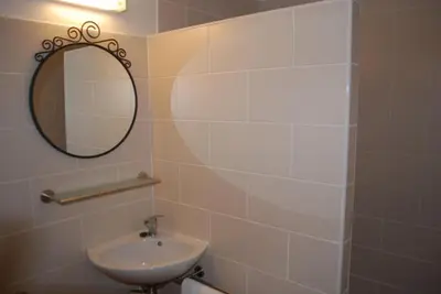 a bathroom with a sink and a mirror at Olivier in Mazan