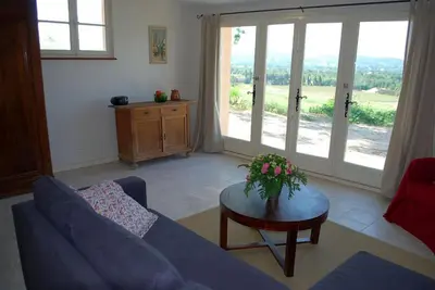 a living room with a blue couch and a table at Olivier in Mazan