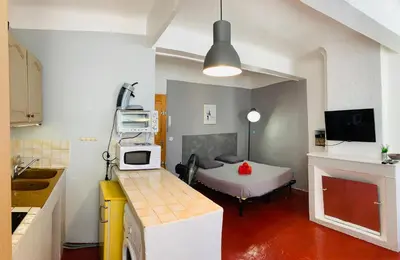 a small room with a bed and a kitchen at Granet Studio in Aix-en-Provence