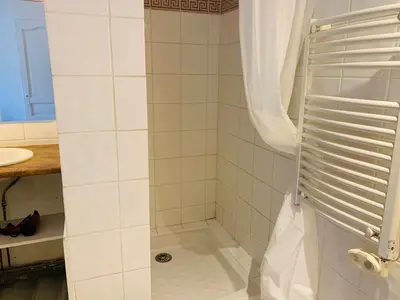 a bathroom with a shower with a sink at Mirabeau Studio in Aix-en-Provence