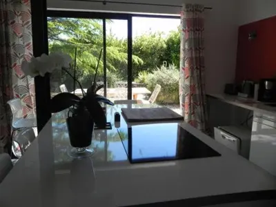 a kitchen with a vase on a counter with a window at La Bastide des Vasses l'Atelier in Cucuron