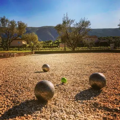a group of spheres sitting on the ground at Le Clos D'Olea in Oppède