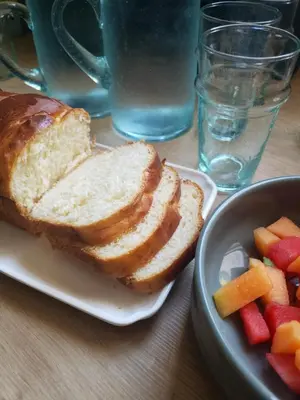 a plate of bread and a bowl of fruit on a table at Le Mas de Garrigon - Boutique Hôtel & Spa in Roussillon