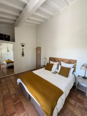 a bedroom with a large bed in a room at Le Mas de Garrigon - Boutique Hôtel & Spa in Roussillon