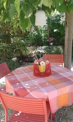 a picnic table with a basket of flowers on it at La Bastide des Vasses 
