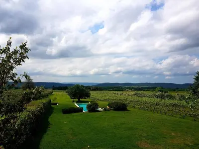 a garden with a pool in the middle of a field at La Bastide des Vasses 