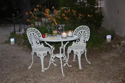 a white table with two chairs and candles on it at Domaine Shambala - gîte en Provence avec une Grande Piscine in Velaux