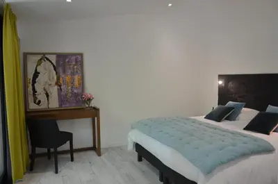 a bedroom with a bed and a desk and a table at Domaine Shambala - gîte en Provence avec une Grande Piscine in Velaux