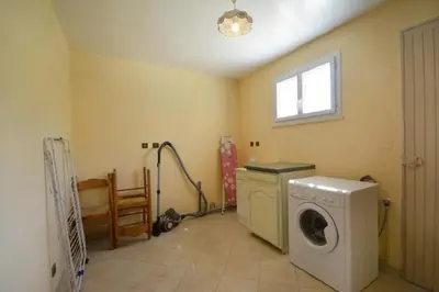 a laundry room with a washing machine and a window at Villa charmante à Saint-Didier avec piscine privée in Saint-Didier