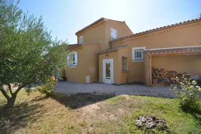 an image of a house with a yard at Villa charmante à Saint-Didier avec piscine privée in Saint-Didier